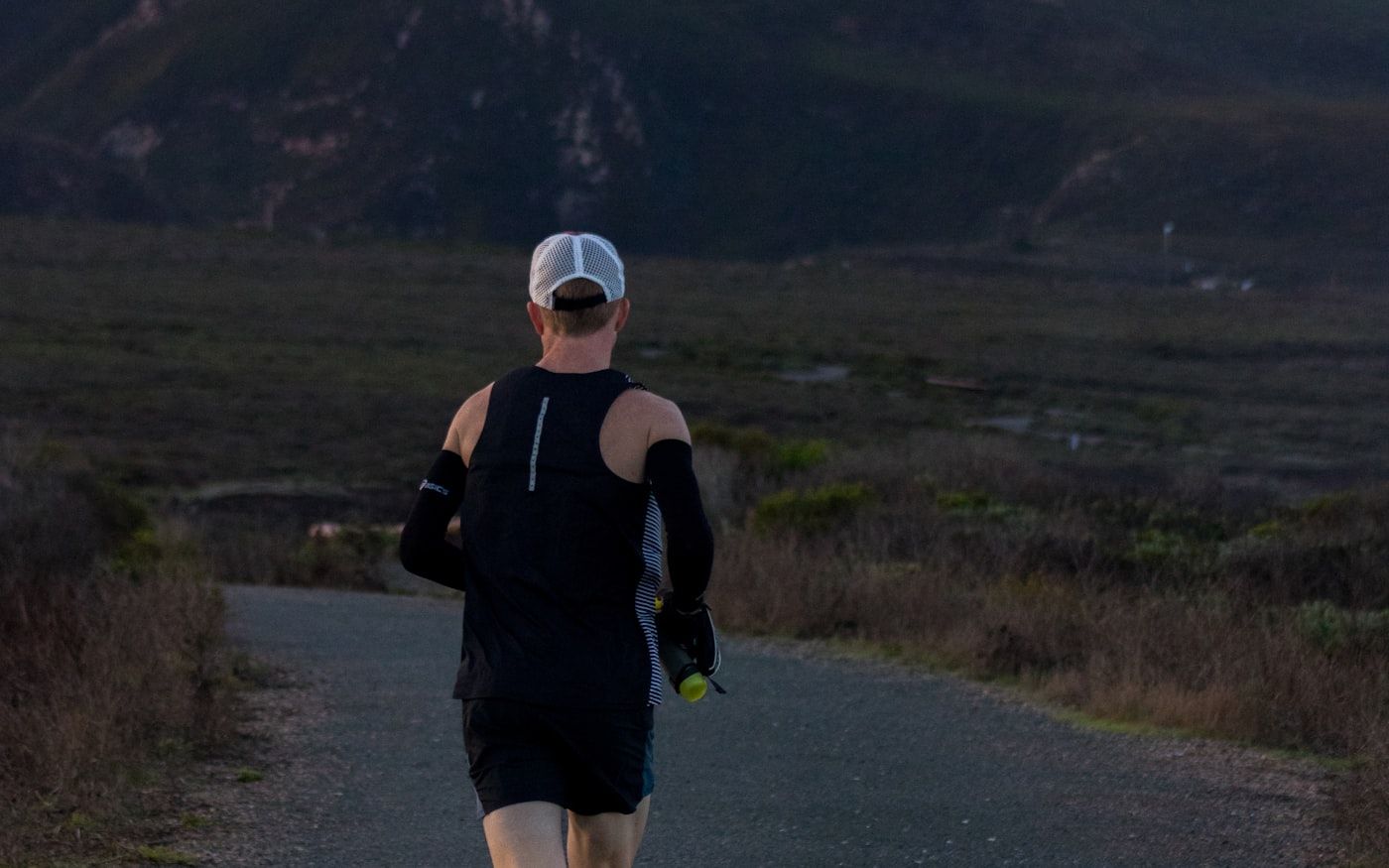 Person jogging outdoors at dusk