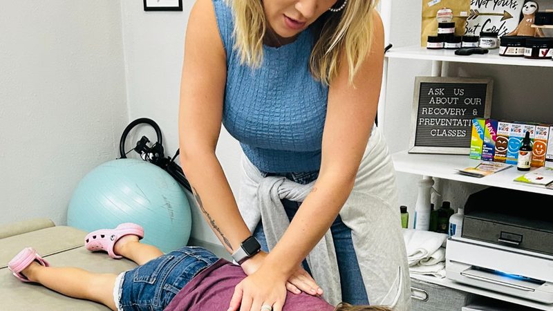 Dr. Whitley Kelley adjusting a pediatric patient at Kelley Sports & Wellness